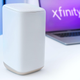 A photo of the router on a tablet with the Xfinity logo in the background